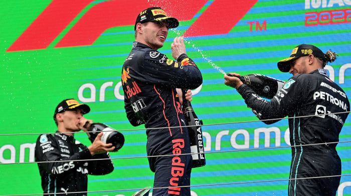 George Russell, Max Verstappen and Lewis Hamilton celebrating on podium after the Hungarian Grand Prix.